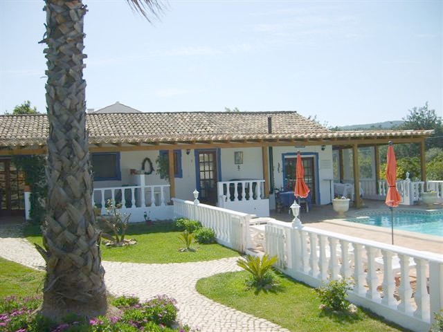Family hotel with swimming pool surrounded by mature gardens